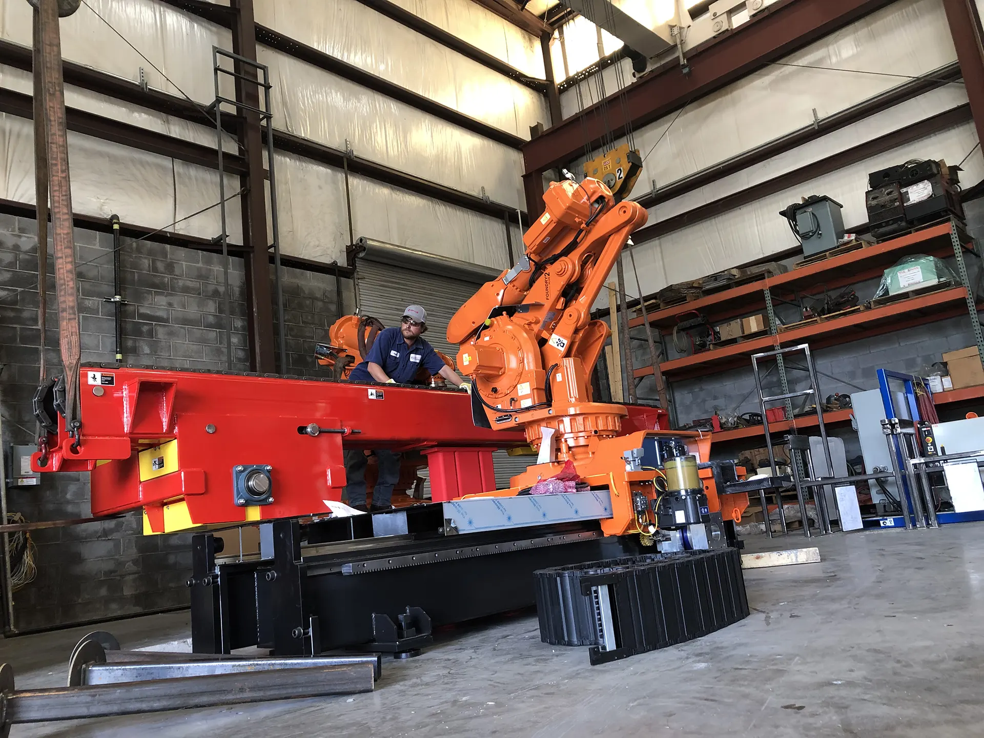 Industrial robot being assembled in a warehouse.